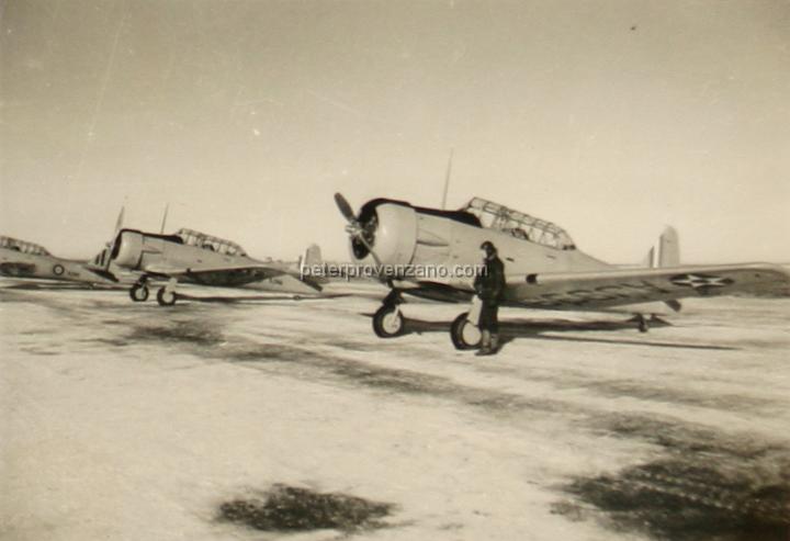Peter Provenzano Photo Album Image_copy_155.jpg - Pilot in front of a US Army Air Corps North American AT-6A Texan. Airplane transfered to the Royal Canadian Air Force (RCAF), but still in US Army Air Corps markings, 1942.